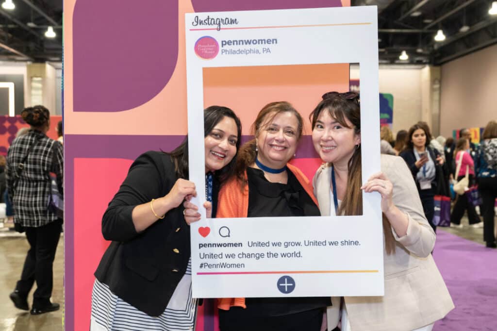 Pennsylvania Conference for Women 2024 attendees holding Instagram cutout